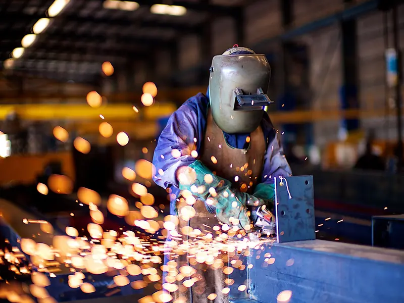 Sparks flying as steel is cut and ground in a fabrication shop